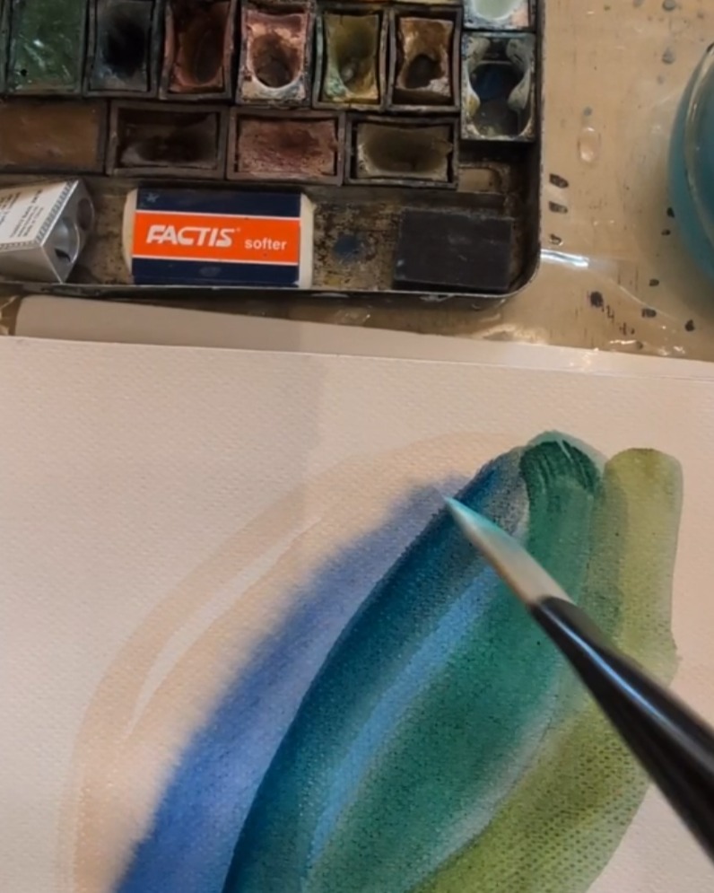 Painting a watercolor gesture in the studio.